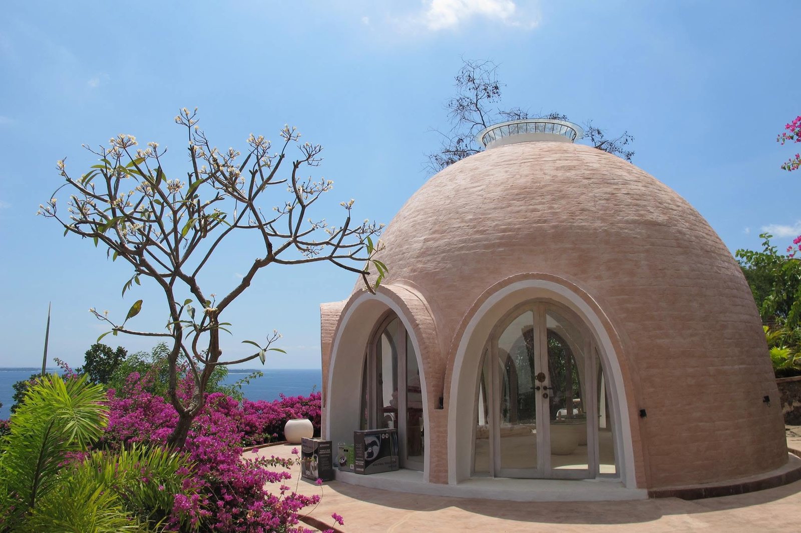 Handcrafted brick dome at Mentigi Bay with frangipani tree