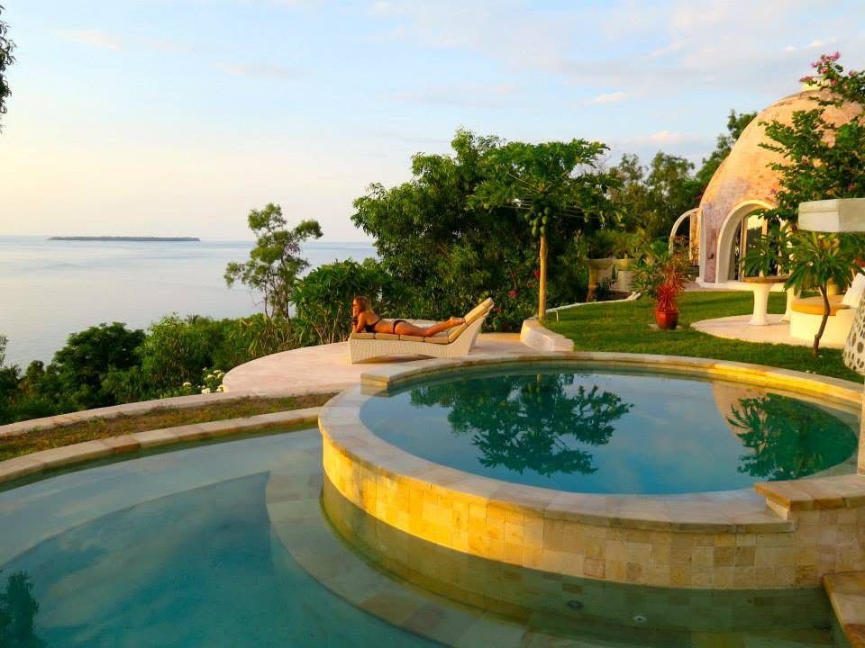 Infinity pool at dusk with the Gili Islands beyond