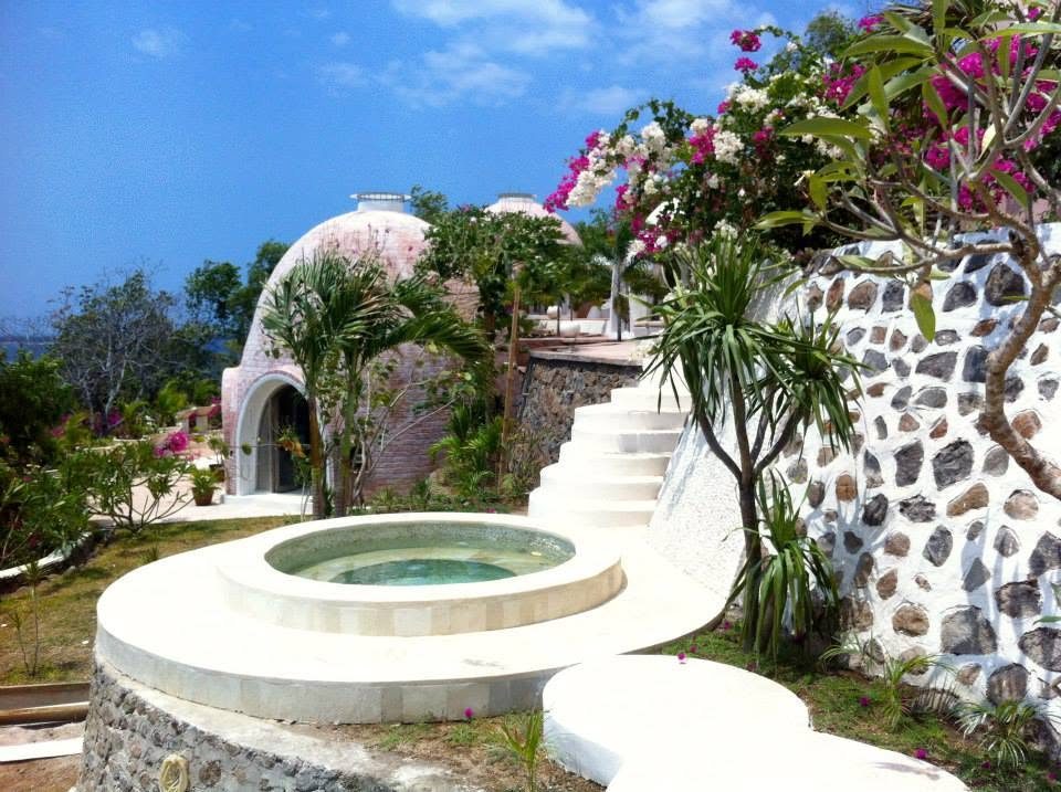 Stone dome and jacuzzi framed by bougainvillea