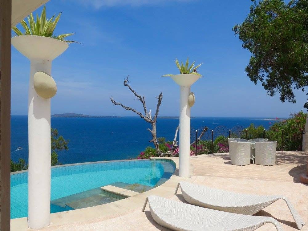 Pool terrace with sculpted planters over the sea