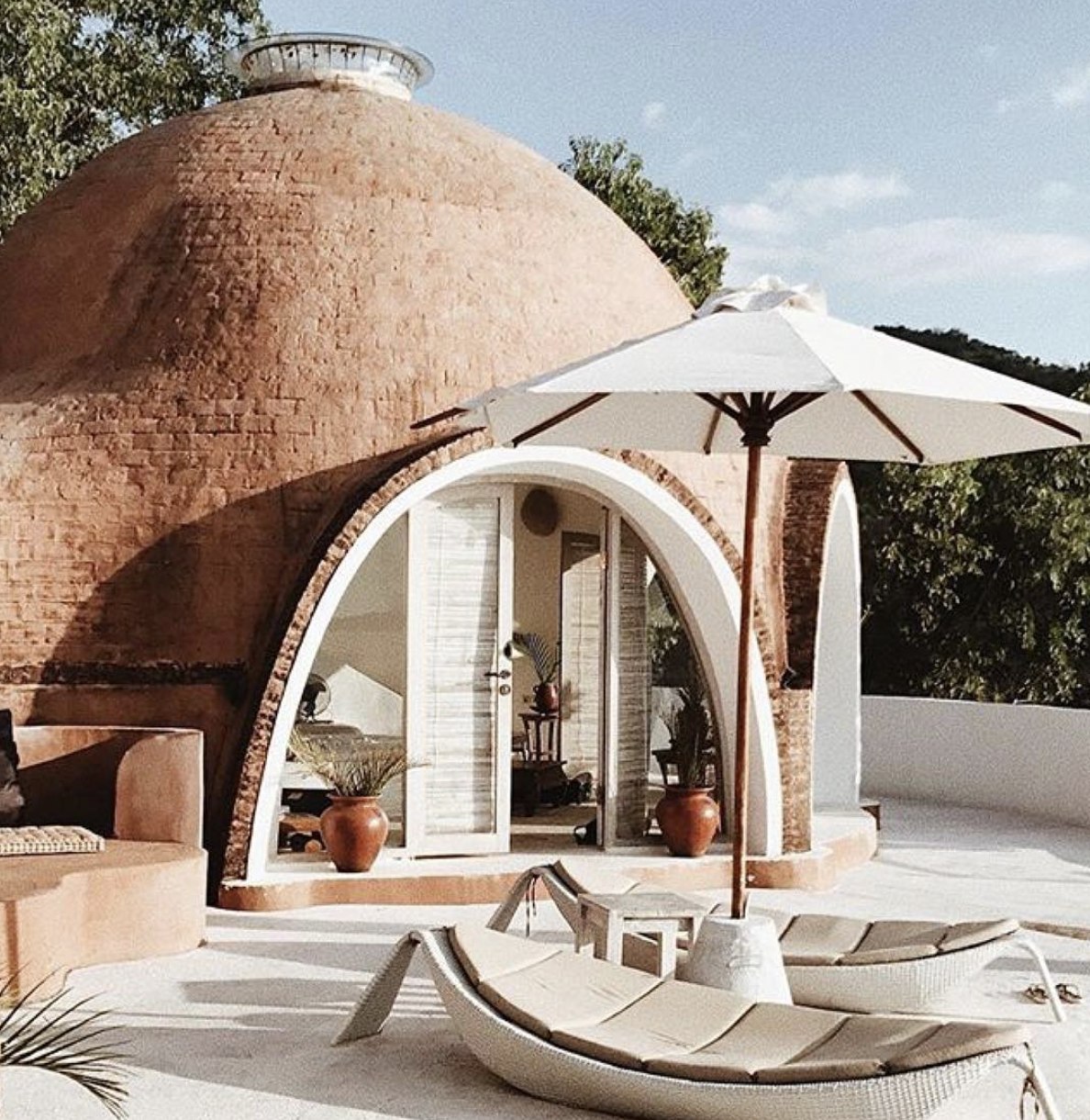Mentigi Bay dome terrace with sun loungers and umbrella